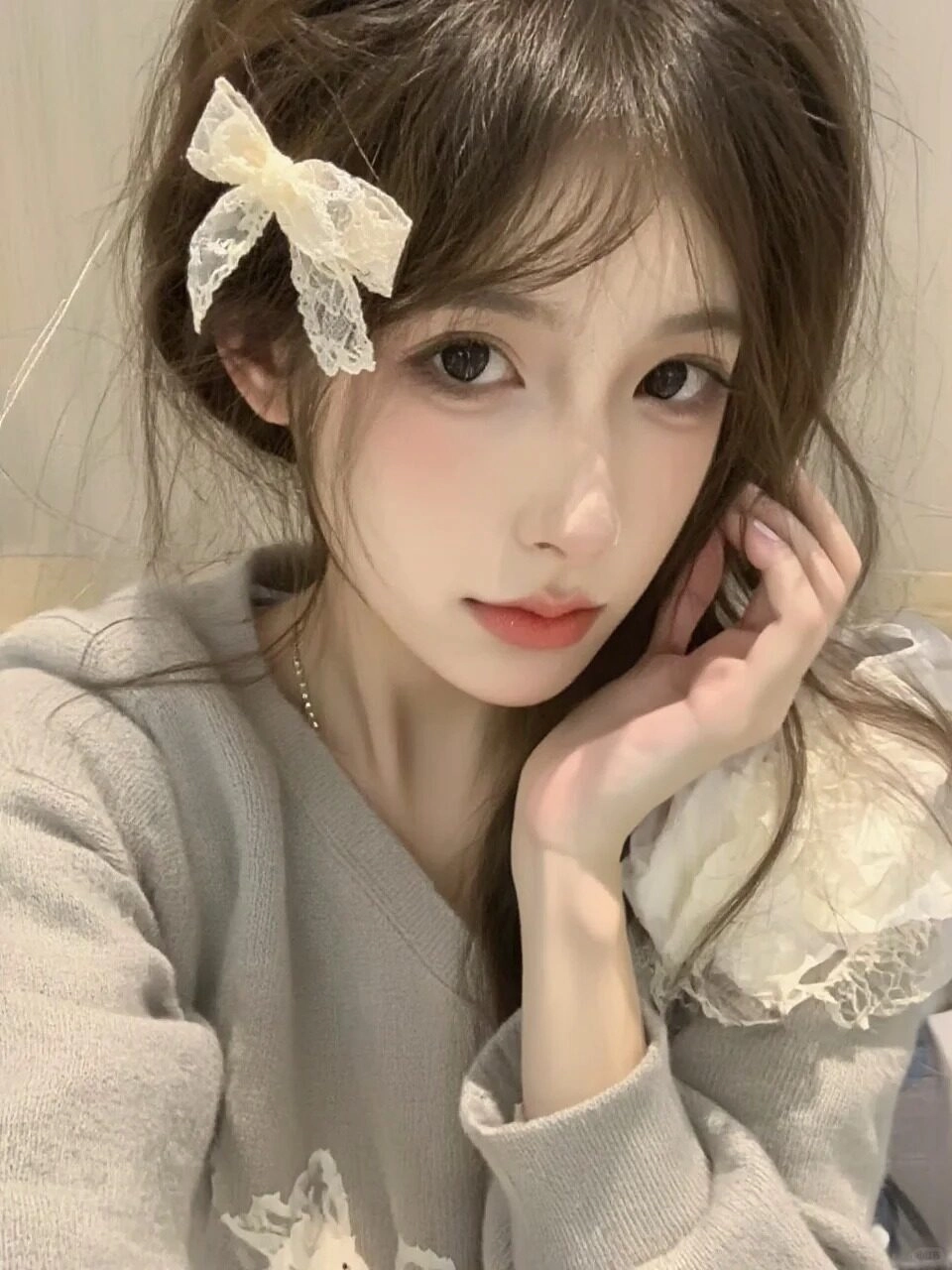 Kiểu tóc buộc nửa điểm xuyết nơ ren tinh tế, phong cách dịu dàng đầy nữ tính.