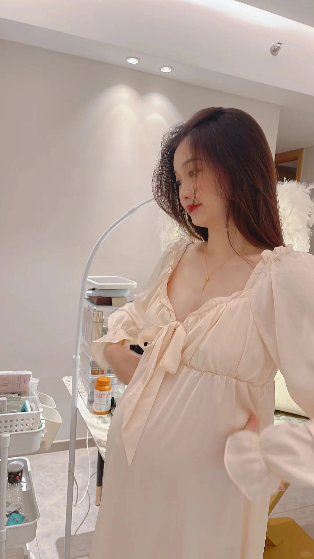 Chiếc váy lụa kem nhẹ nhàng ôm trọn vóc dáng mẹ bầu đầy quyến rũ.