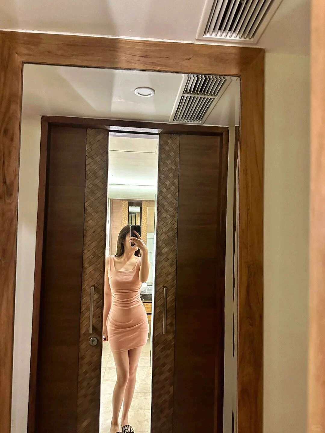 Váy body hồng pastel mũi ống, cô gái với thân mình thanh mảnh bên ống kính lớn.